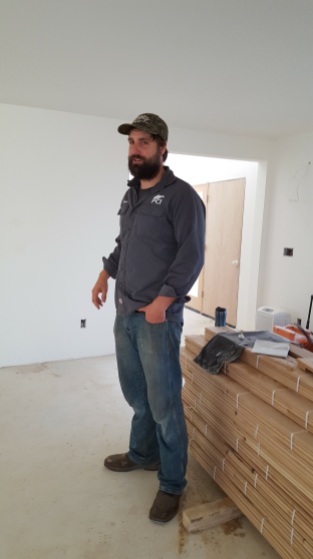Here is Casey, the foreman on our job, with the shipment of hardwood flooring